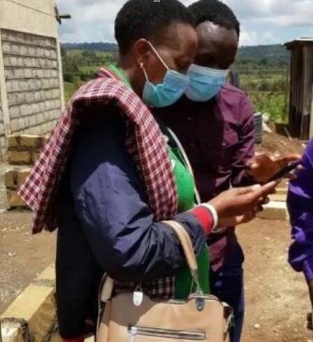 Kenyan farmer using weather intelligence on her phone Kenyan farmer using weather intelligence on her phone